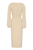 Knitted midi dress featuring fitted silhouette and logn sleeves.