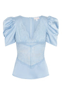 Feminine, lace blouse designed with padded shoulders.