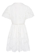Feminine mini dress featuring white embroidery.